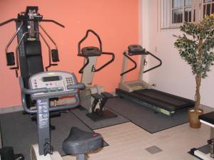 a gym with two tread machines and a treadmill at Gästehaus Pfatischer Hotel Fewo in Rottach-Egern