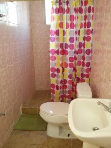 a bathroom with a toilet and a shower curtain at Hotel Contadora in Contadora