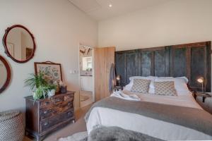 a bedroom with a large bed with a wooden headboard at The Potting Shed in Newquay