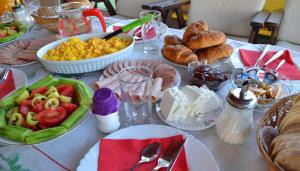 a table topped with plates of food and pastries at Villa D&L in Ohrid