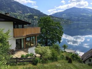 a house with a view of a lake and mountains at Seehaus Weiss in Rothenthurn