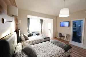 a hotel room with two beds and a tv at Skopje Arch Residence in Skopje