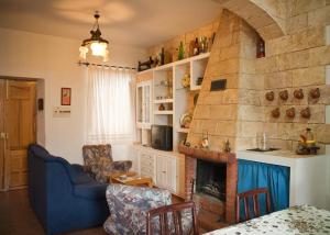 a living room with a fireplace and a blue couch at Vivienda Rural El Mirador de Enix in Enix