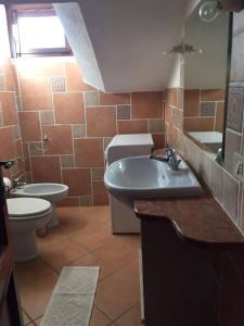 a bathroom with a tub and a toilet and a sink at Casa Gallo in Santa Marinella