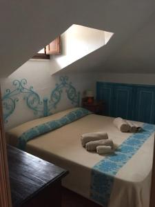 a bedroom with two towels sitting on a bed at Casa Gallo in Santa Marinella
