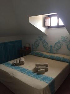 a bedroom with a bed with towels and a window at Casa Gallo in Santa Marinella