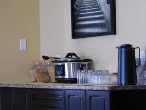 a kitchen counter with a coffee maker on a counter top at Lakeshore Inn in Cold Lake