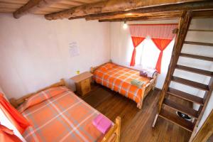 Postel nebo postele na pokoji v ubytování Hostal Taita Cristobal