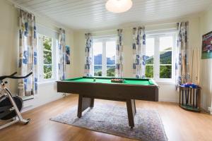 a pool table in a room with windows at Rasmusgarden in Stranda