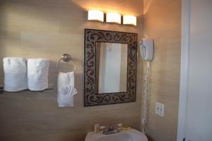 a bathroom with a sink and a mirror and towels at La Terrace Oceanfront in Hollywood +78 photos