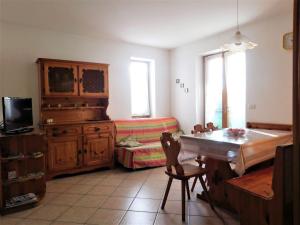 a living room with a bed and a couch at Appartamento Zorzi in Ziano di Fiemme
