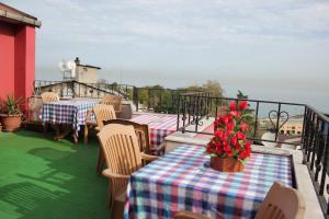 a balcony with tables and chairs and a view of the ocean at Nazar Hotel in Trabzon