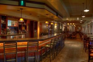 a restaurant with a bar and dinning area at The Steamboat Grand in Steamboat Springs