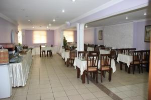 a dining room with tables and chairs in a restaurant at Nazar Hotel in Trabzon