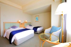 Tempat tidur dalam kamar di Palace Hotel Tachikawa