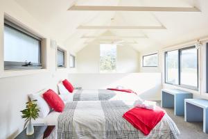 
a bedroom with a bed and a window at Great Ocean Walk Retreat in Glenaire

