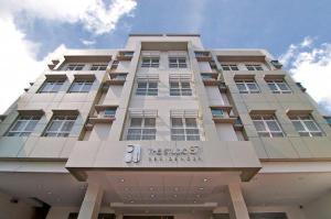 a building with a sign on the front of it at The Studio 87 Residences in Manila