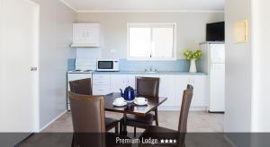 a kitchen with a table and chairs in a room at Saltbush Retreat in Longreach