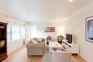 a living room with a couch and a tv at Solhaven in Fremantle