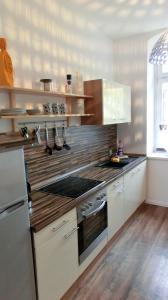 a kitchen with a stove and a refrigerator at Apartment KiezFlair in Potsdam
