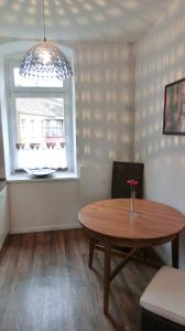 a dining room with a table and a window at Apartment KiezFlair in Potsdam