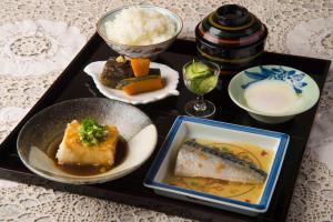a tray of food with a plate of fish and rice at Hotobil B&B 潤 An inn that enjoys breakfast in Nara