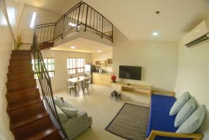 a living room with a staircase and a living room at Felix Residences in Cebu City