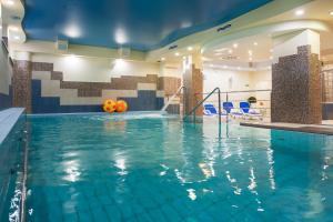 a pool in a hotel room with a swimming pool at Centrum Zdrowia i Wypoczynku Ikar in Kołobrzeg