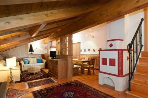 a living room with a fireplace in a house at Appartamenti Royal in San Vito di Cadore