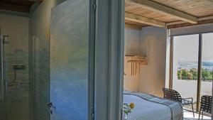 a bedroom with a bed and a glass shower at Torre dei Sogni in Poppi