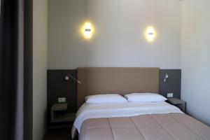 a bedroom with a large bed with two pillows at Donati Business Rooms in Subbiano