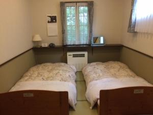 Un pat sau paturi într-o cameră la Shikino Yado Subaru