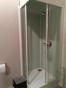 a shower with a glass enclosure in a bathroom at Lougat la maison des chats in Cordes-sur-Ciel