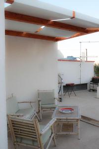 a patio with two chairs and a table with at Casa "da Paola" in San Vito lo Capo +18 photos