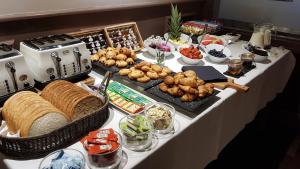 a buffet table with bread and other foods on it at Heywood Spa Hotel in Tenby