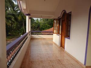 a corridor of a house with a door and a balcony at Lobo's Guesthouse in Cavelossim