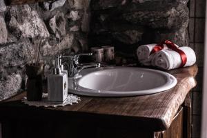 a bathroom with a sink and rolls of toilet paper at La Peiro Douco in Roure Turin +64 photos