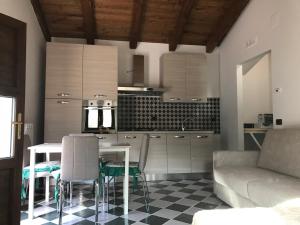 a kitchen with a table and chairs and a couch at Borgo Donna Teresa in Castel San Vincenzo