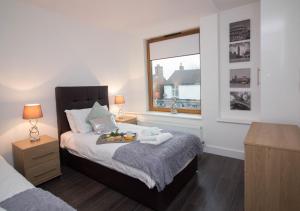 a bedroom with a bed with a fruit tray on it at Britannia Chambers in Leek