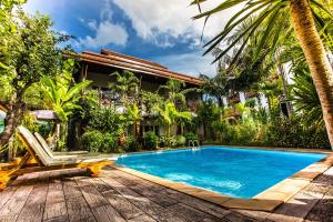 a swimming pool in front of a house with a resort at Pingdoi Hualin Boutique Hotel in Chiang Mai