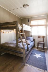 a bedroom with a bunk bed with a blue rug at Stranda Alpegrend in Stranda