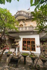 a building with trees in front of it at Bay View House in Padangbai