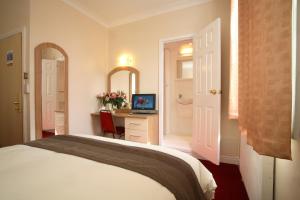 
a hotel room with a bed and a television at Lloyds of Chester in Chester

