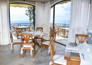 a dining room with a table and chairs on a balcony at BlackSeaRama Golf & Villas in Balchik