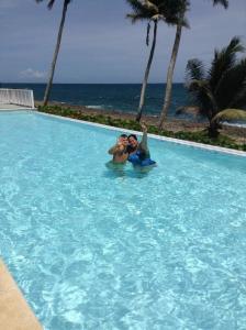 a man and a woman in a swimming pool at Apartamento Juan Dolio in Juan Dolio +11 photos