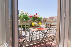 a balcony with a table and chairs on a balcony at Premium Historic Center & Parking in Málaga