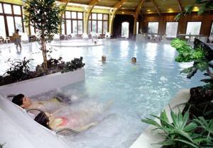 a group of people swimming in a swimming pool at Malalcahuello Thermal Hotel & Spa in Malalcahuello