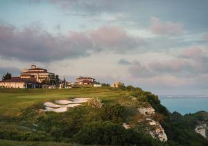 a group of golf greens on a hill next to the ocean at Club Residence at BlackSeaRama Golf in Balchik
