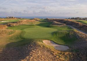 an aerial view of a golf course with the ocean in the background at Club Residence at BlackSeaRama Golf in Balchik