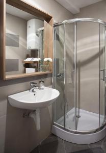 a bathroom with a sink and a shower at Brzeće Center Apartments in Kopaonik